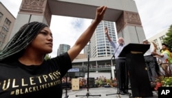 FILE - Mara Jacqueline Willaford of Black Lives Matter holds her fist overhead as Democratic presidential candidate Sen. Bernie Sanders, I-Vt., greets the crowd in downtown Seattle, Washington, Aug. 8, 2015. Black Americans tend to vote Democratic in presidential elections.