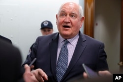 FILE - U.S. Agriculture Secretary Sonny Perdue speaks with reporters on Capitol Hill in Washington, April 11, 2018.