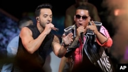 FILE - singers Luis Fonsi, left and Daddy Yankee perform during the Latin Billboard Awards in Coral Gables, Fla.