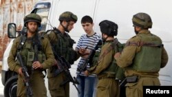 Tentara Israel mencari seorang remaja Palestina dalam operasi untuk mencari tiga remaja Israel yang diculik, di Hebron, Tepi Barat (16/6). 