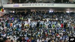 People attend a prayer service led by Mahmoud Dicko, an imam who helped lead the opposition protests, for those who died or were injured during the protests, in Bamako, Mali, Aug. 28, 2020. 
