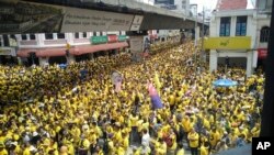 Protesters occupy a street during a rally in downtown Kuala Lumpur, Malaysia, Saturday, Nov. 19, 2016. Tens of thousands of yellow-shirt protesters rallied Saturday in Kuala Lumpur seeking Malaysian Prime Minister Najib Razak's resignation over a financial scandal, undeterred by a police ban and the arrest of more than a dozen activists.