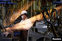 A man works in the automobile production line of the new Honda plant in Prachinburi, Thailand, May 12, 2016.