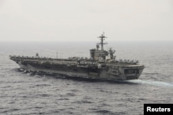 FILE - The aircraft carrier USS Theodore Roosevelt (CVN 71) transits the South China Sea in this U.S. Navy picture taken Oct. 29, 2015.