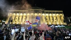 Protesters rally against the "foreign influence" law outside the parliament in Tbilisi, Georgia, on May 15, 2024. Georgian President Salome Zourabichvili vetoed the recently passed measure on May 18, 2024.