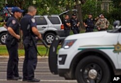 Law enforcement officers man a road block after police officers were shot earlier in the day in Baton Rouge, Louisiana, July 17, 2016.
