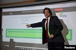 FILE - Prateek Hajela, Assam's chief co-coordinator of the National Register of Citizens (NRC), demonstrates how to check a name online on its website after the publication of the first draft of the NRC in Guwahati city in the northeastern state of Assam,