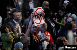 A delegate holds an anti-Trans-Pacific Partnership (TPP) trade agreement sign during the first day of the Democratic National Convention in Philadelphia, July 25, 2016.