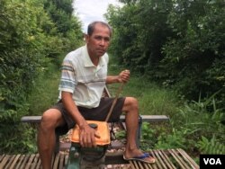 Pheach Tum, 52, has been a bamboo train driver for almost 20 years. His wife is a food vendor at the train station. Their income depends heavily on this tourism site. (Sun Narin/VOA Khmer)