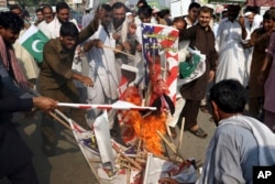 Pakistani protesters burn posters of U. S. President Donald Trump in Peshawar, Pakistan, Aug. 30, 2017. Protesters have objected to Trump's allegation that Islamabad is harboring militants who battle U.S. forces in Afghanistan.