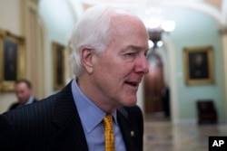 FILE - Senate Majority Whip Sen. John Cornyn, R-Texas, talks with reporters on Capitol Hill, Oct. 11, 2018.