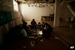 In this Aug. 22, 2018 photo, Yazidi children work on arts and crafts in the basement of an orphanage in Sheikhan, Iraq.