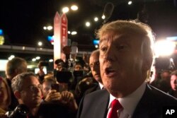 Republican presidential candidate Donald Trump speaks to the media in the spin room after the first Republican presidential debate at the Quicken Loans Arena Thursday, Aug. 6, 2015.