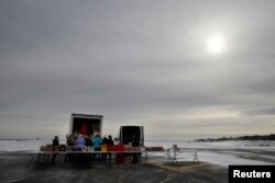 Volunteers and staff of Gather food pantry set up as they prepare to distribute food to members of the U.S. Coast Guard, who are working without pay during the government shutdown, at the U.S. Coast Guard Portsmouth Harbor base in New Castle, N.H., Jan. 23, 2019.