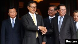 លោក​​​នាយក​​​រដ្ឋ​​​មន្ត្រី​​​ ហ៊ុន​​​ សែន​​​កំពុង​​​ចាប់​​​ដៃ​​​គ្នា​​​ជាមួយ​​​លោក​​​​​​ សម​​​ រង្ស៊ី​​​ ប្រធាន​​​គណបក្ស​​​សង្គ្រោះ​​​ជាតិ​​​បន្ទាប់​​​ពី​​​កិច្ច​​​ប្រជុំ​​​នៅ​​​មន្ទីរ​​​ព្រឹទ្ធ​​​សភា​​​​​​ ដែល​​​ឈាន​​​ដល់​​​ការ​​​បញ្ចប់​​​វិបត្តិ​​​ជាប់​​​គាំង​​​នយោបាយ​​​នៅ​​​កម្ពុជា​កាល​​​​​ពី​​​ថ្ងៃ​​​ទី​ ២២​​​ ខែ​​​កក្កដា​​​ ឆ្នាំ​​​២០១៤​​​។​​​ 