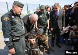 EU Commissioner of Migration Dimitris Avramopoulos poses for a picture with border police from Finland during the official launch of the European Union's Border and Coast Guard Agency at a border crossing on the Bulgarian-Turkish border in Kapitan Andreev