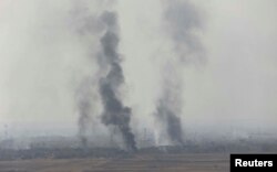 Smoke rises from clashes at Bartila in the east of Mosul during clashes with Islamic State militants, Iraq, Oct. 18, 2016.