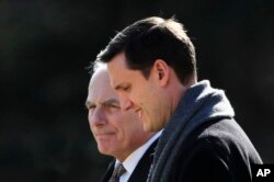 White House staff secretary Rob Porter, right, walks with White House Chief of Staff John Kelly to board Marine One on the South Lawn as they leave the White House in Washington, Feb. 2, 2018.