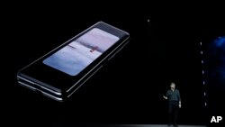 Justin Denison, SVP of Mobile Product Development, talks about the new Samsung Galaxy Fold smartphone during an event Wednesday, Feb. 20, 2019, in San Francisco. (AP Photo/Eric Risberg)