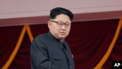 FILE - North Korea's leader Kim Jong Un watches a parade in Pyongyang, May 10, 2016. The U.S. imposed sanctions July 6, 2016, on North Korean leader Kim Jong Un and 10 other top officials for human rights abuses.