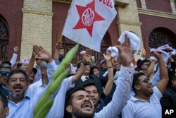 Supporters of Peru's late President Alan Garcia chant slogans during his funeral procession in Lima, Peru, April 19, 2019.