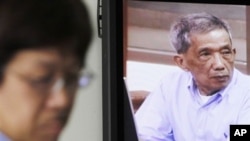 Kaing Guek Eav, also known as Duch, who ran the notorious Toul Sleng, a top secret detention center for the worst "enemies" of the state, appears on a television screen of the press center of the U.N.-backed war crimes tribunal in Phnom Penh, 2010.
