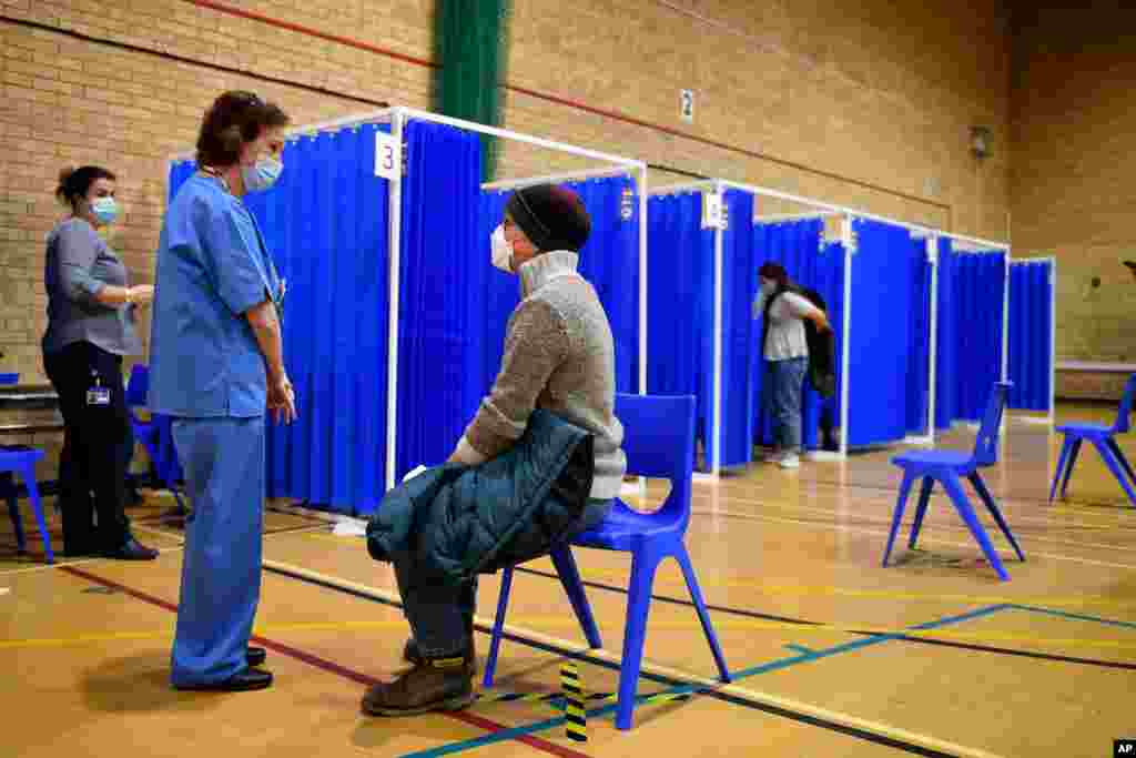 Medical staff in booths prepare to administer the Pfizer-BioNTech COVID-19 vaccine at a vaccination centre in Cardiff, Wales, Dec. 8, 2020.