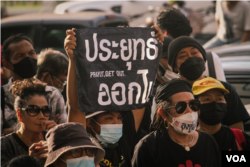 A protester holds up a sign directed against Thailand’s Prime Minister Prayut Chan-o-Cha during Saturday's anti-government demonstrations in Bangkok, Thailand, Oct. 1, 2022, (Tommy Walker/VOA)
