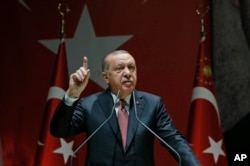 Turkey's President Recep Tayyip Erdogan talks to members of his ruling Justice and Development Party (AKP), in Ankara, Turkey, Oct. 26, 2018.