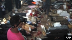 A man looks at bodies laid out in a make shift morgue after Egyptian security forces stormed two huge protest camps at the Rabaa al-Adawiya and Al-Nahda squares where supporters of ousted president Mohamed Morsi were camped, in Cairo, on August 14, 2013.