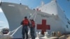 Boatswain's Mate 3rd Class Taryn Armington and Sonar Technician (Surface) Seaman Darian Joseph prepare to cast off mooring lines for the Military Sealift Command hospital ship USNS Comfort.