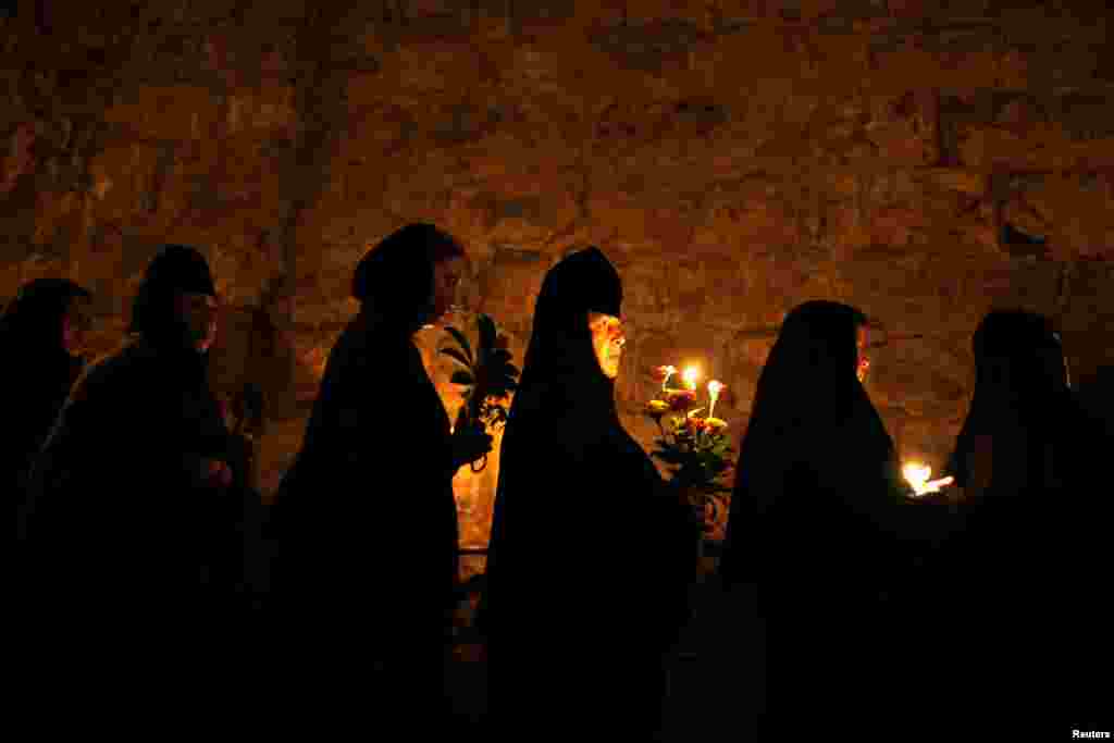 Orthodox Christian nuns take part in an annual procession along the Via Dolorosa in Jerusalem's Old City. An icon of the Virgin Mary is carried from the Church of the Holy Sepulchre to a church at the foot of the Mount of Olives, the location believed by Christians to be that of the tomb of the Virgin Mary.