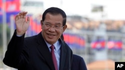 Cambodia's Prime Minister Hun Sen greets his government officials as he arrives to watch the boat races at the Royal Palace during the annual water festival in Phnom Penh, Cambodia, Thursday, Nov. 2, 2017.