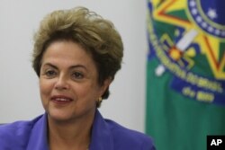 FILE - Brazil’s President Dilma Rousseff meets with women rural workers at Planalto Presidential Palace in Brasilia, Brazil, Thursday, Aug. 6, 2015.