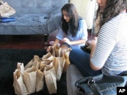 Giving to the less fortunate - these young Muslims are preparing bagged lunches for the homeless - is an important part of Ramadan.