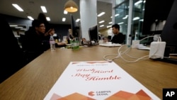FILE - Employees of Chatting Cat company, a startup and ventures investors, work during a media tour at the Google campus in Seoul, South Korea, May 8, 2015. Seoul is the site of Google's first campus for startups and entrepreneurs in Asia.
