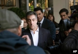 FILE - Michael Cohen, former attorney to President Donald Trump, leaves his apartment building before beginning his prison term, May 6, 2019, in New York.