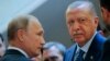 Russian President Vladimir Putin (L) and Turkish President Recep Tayyip Erdogan prepare to enter a hall for their talks at the Bocharov Ruchei residence, in Sochi, Russia, Sept. 17, 2018. 