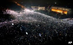Tens of thousands of people gather for a demonstration in from of the government building in Bucharest, Romania, Sunday, Feb. 5, 2017.