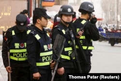 China-Armed police keep watch in a street in Kashgar, Xinjiang Uighur Autonomous Region, China, March 24, 2017. REUTERS/Thomas Peter/File Photo