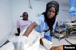 A paramedic at Kalkaal hospital attends to a man injured during a suicide bomb attack near the Sahafi Hotel in Mogadishu, Somalia, Nov. 10, 2018.