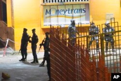 Congolese riot police take position around the electoral commission building at night in Kinshasa, Congo, Jan. 8, 2019.