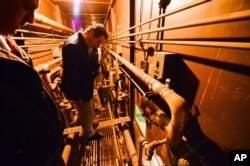 This photo provided by New York state governor's office shows Gov. Andrew Cuomo on a catwalk, looking into the cell that inmates escaped from at a maximum-security prison near the Canadian border in Dannemora, N.Y., June 6, 2015.