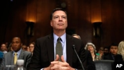 FILE: Then-FBI Director James Comey prepares to testify on Capitol Hill in Washington, May 3, 2017, before the Senate Judiciary Committee.