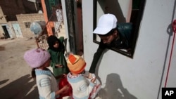 FILE - Yemeni children receive free food donated by Yemeni volunteers during the holy month of Ramadan, in Sanaa, Yemen, June 11, 2016.