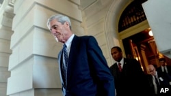 FILE - Former FBI Director Robert Mueller, the special counsel probing Russian interference in the 2016 election, departs Capitol Hill.