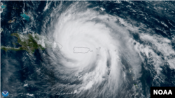 FILE - The center of Hurricane Maria approaches the northern coast of Puerto Rico in this geocolor image captured by NOAA's GOES-16, Sept. 20, 2017.