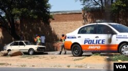 Traffic police fine a motorist in Johannesburg. Robert van Rensburg says if they stop him for drunken driving, he simply bribes them to let him go. (D. Taylor/VOA)