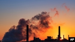 FILE - The Dave Johnson coal-fired power plant is silhouetted against the morning sun in Glenrock, Wyoming, July 27, 2018. Energy is big business in Wyoming.