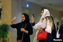 FILE - Saudi people attend the concert of composer Yanni at Princess Nourah bint Abdulrahman University in Riyadh, Saudi Arabia, Dec. 3, 2017.